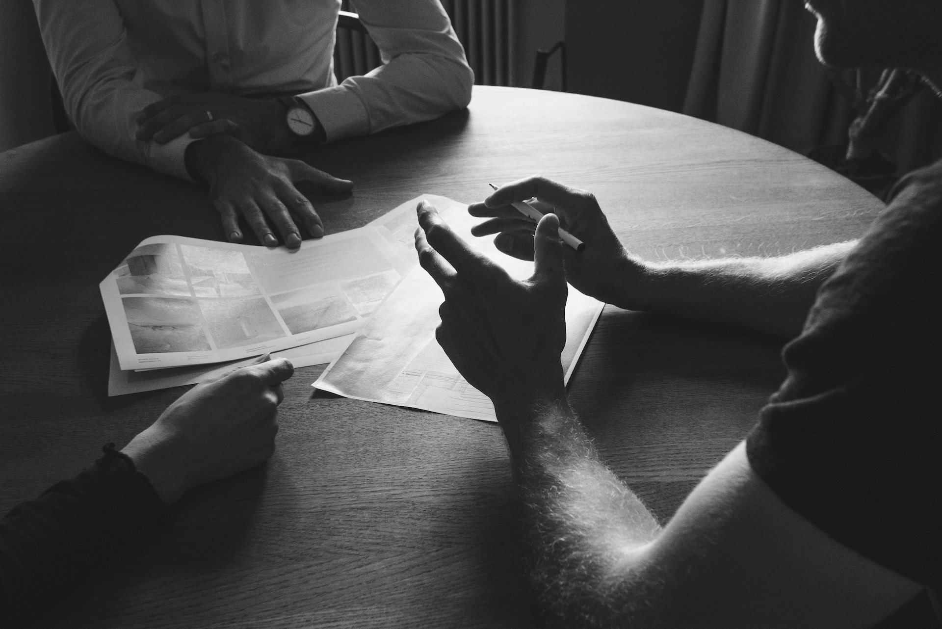 Brannock-Humphries-Partnership people sitting at table talking